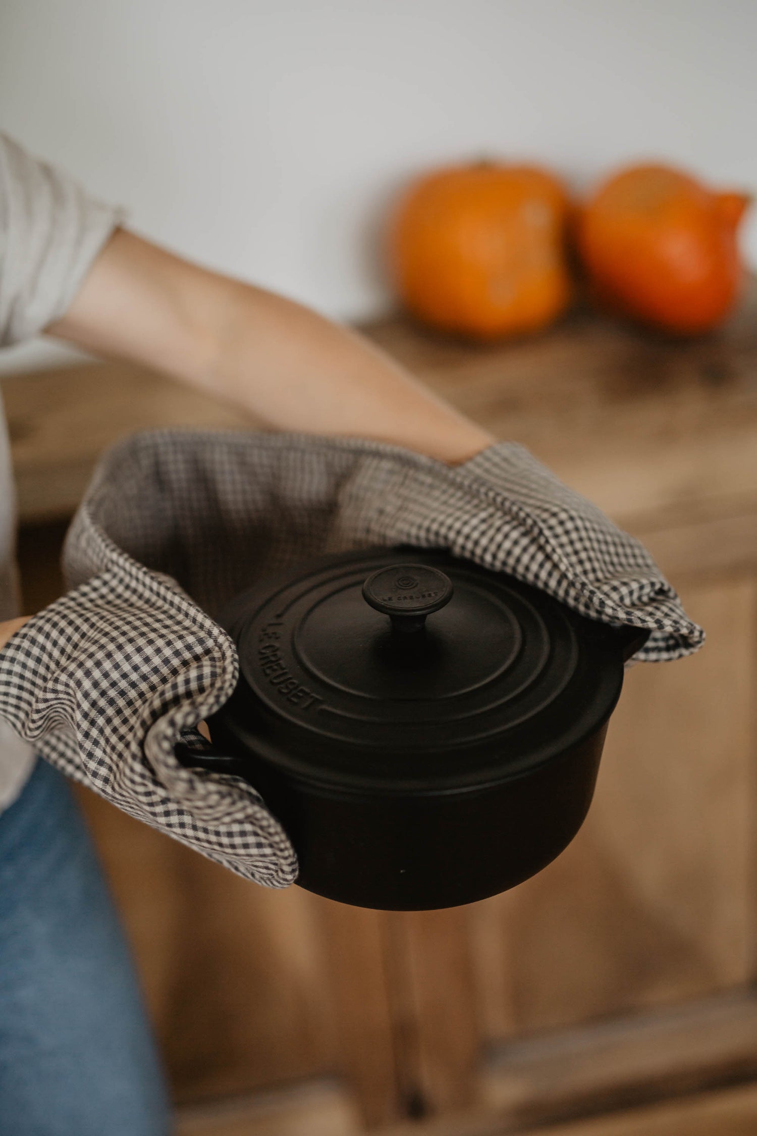 linen double oven mitts used to hold hot soup pot