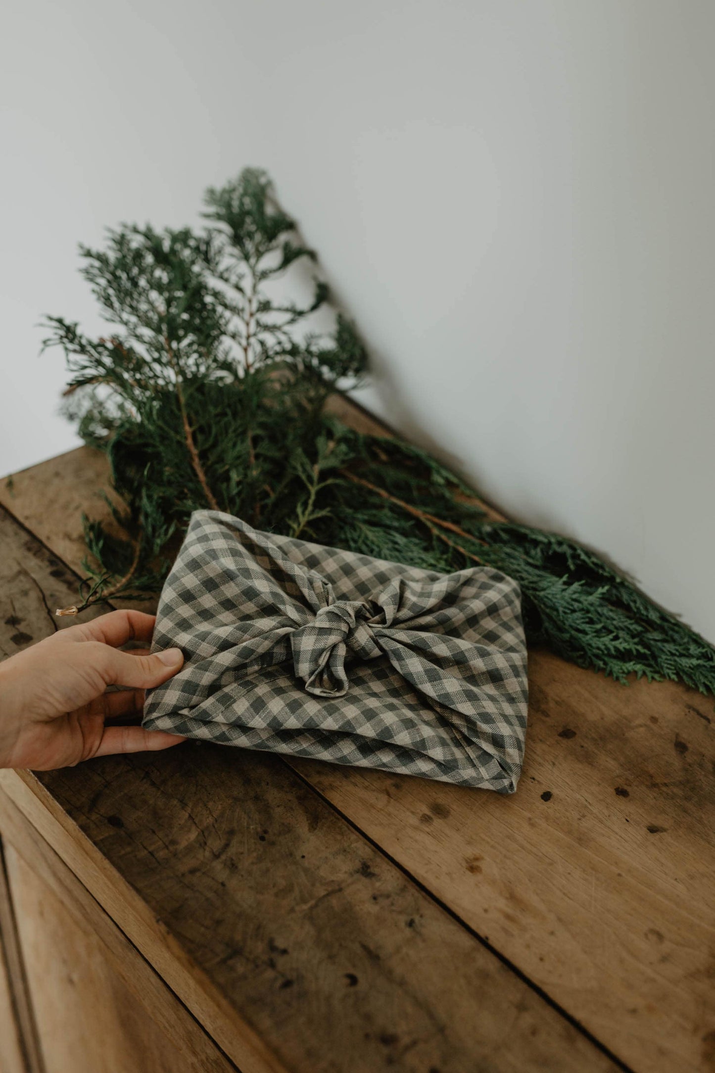 present wrapped in dark blue furoshiki linen wrapping